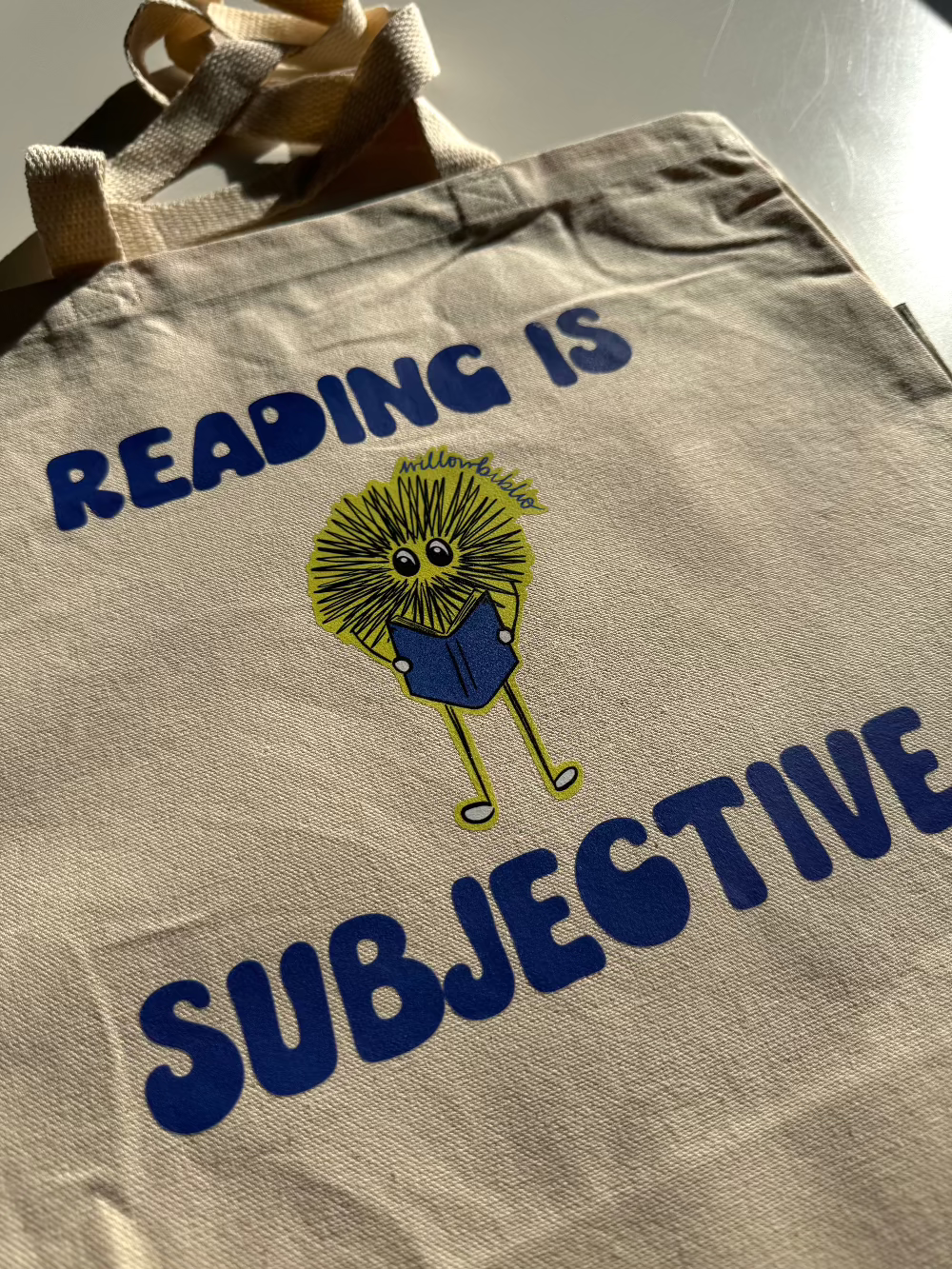 reading is subjective logo tote bag